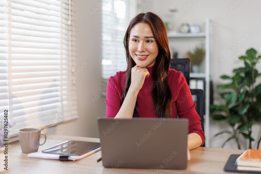 Young Asian girl or Asian businesswoman working at home office with a laptop
Young Asian girl or Asian businesswoman working at home office with a laptop