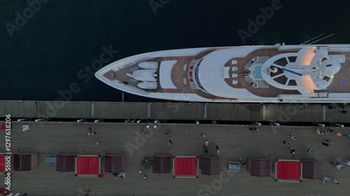 Top View A Luxury Yacht With A Helicopter On Deck, Moored In Halifax Harbour. The Illuminated City Skyline And Reflections In The Water Make This A Beautiful Sunset View Of Nova Scotia.