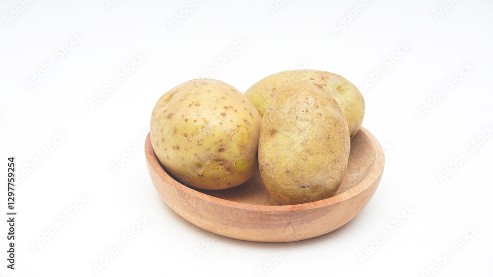 Three Potatoes on Wooden Plate Isolated on White Background Three Potatoes on Wooden Plate Isolated on White Background