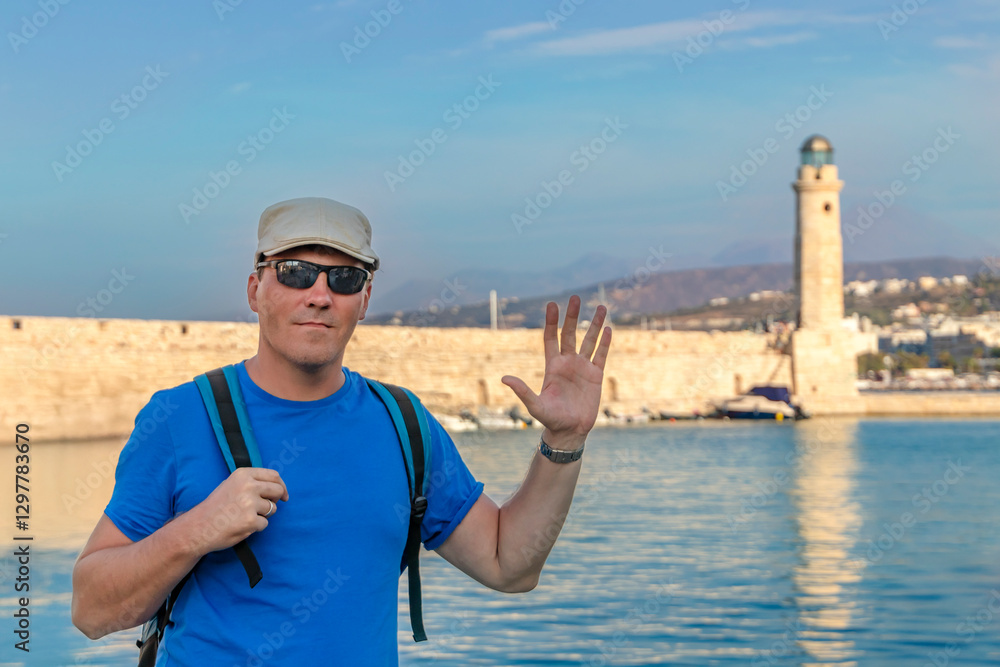 A Very Happy Traveler is Enjoying the Beautiful Scenic Coastal Lighthouse in Picturesque Greece. Greece. Rethymnon