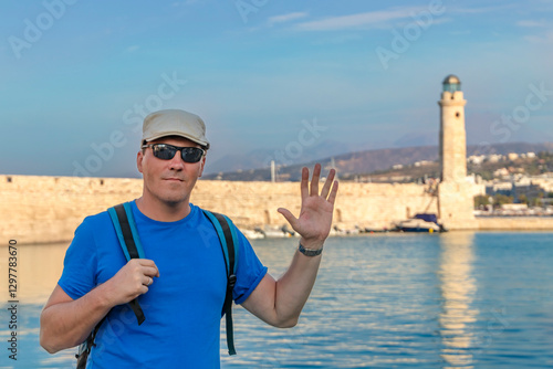 Obraz na płótnie A Very Happy Traveler is Enjoying the Beautiful Scenic Coastal Lighthouse in Picturesque Greece. Greece. Rethymnon w salonie