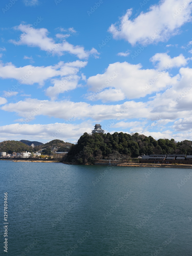 Inuyama Castle in Aichi Prefecture, Japan: A national treasure castle shining against the blue sky. February 11, 2025 Inuyama Castle in Aichi Prefecture, Japan: A national treasure castle shining against the blue sky. February 11, 2025