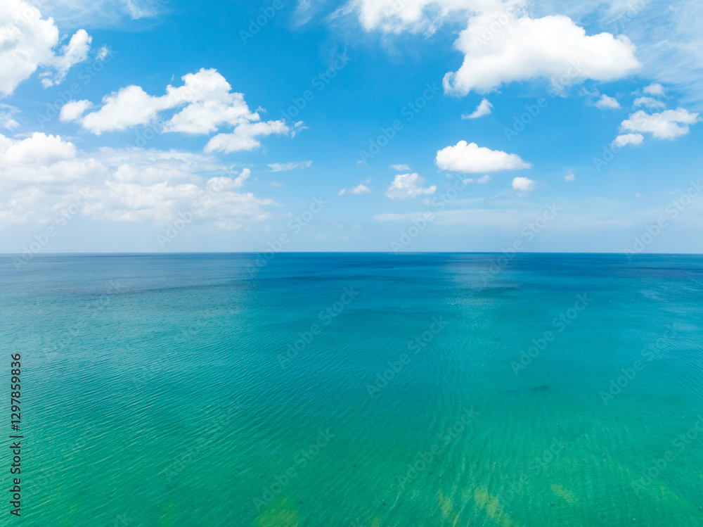 Obraz premium Aerial view of beautiful sea in summer season sky background,Drone view Waves water surface texture on sunny tropical ocean in Phuket island Thailand