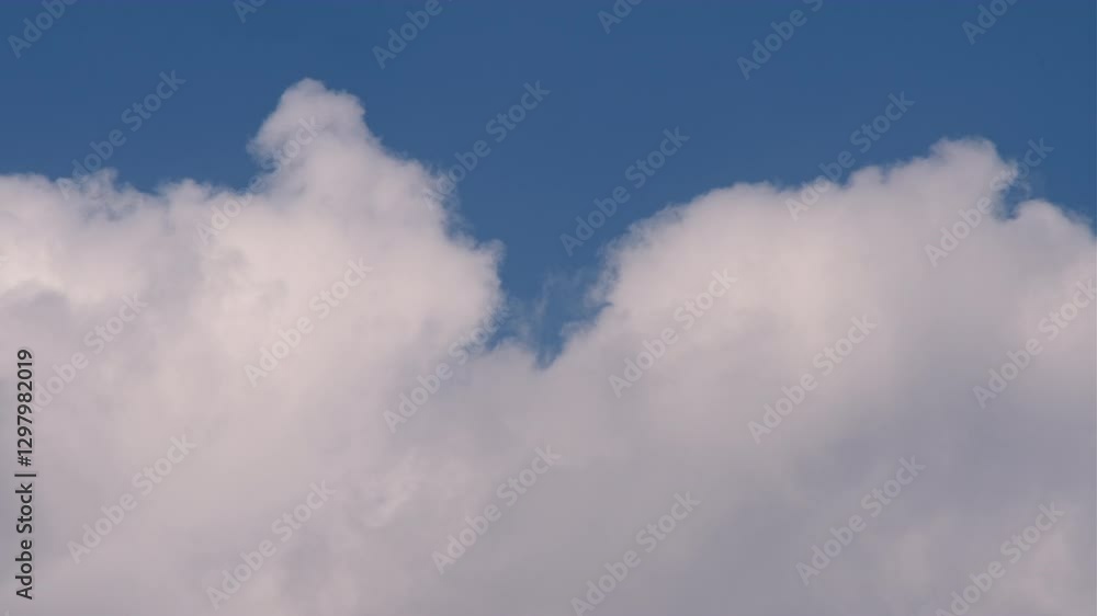Time Lapse of A serene blue sky with fluffy white clouds evoking feelings of peace and freedom The clouds add depth and texture creating a visually captivating skyscape Time Lapse of A serene blue sky with fluffy white clouds evoking feelings of peace and freedom The clouds add depth and texture creating a visually captivating skyscape