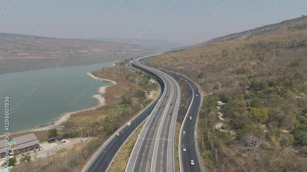 The M6  motorway Expressway Nakhon Ratchasima Province - Bang Pa-in. Lam Ta Khong River and Mountain. Drone shot of scenic landscape rural place traffic. Nakhon Ratchasima Thailand. Motorway Korat