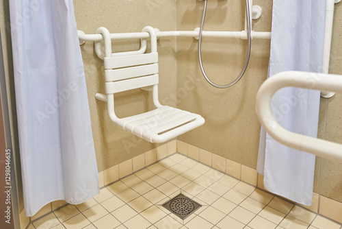 A bathroom with a chair in the shower in the hospital, designed for the disabled and people with disabilities, with tiled floors and walls. High quality photo