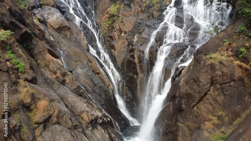 Aerial view of Dudhsagar Falls or Sea of Milk surrounded with lush vegetation located deep in the rainforest of South Goa, India.