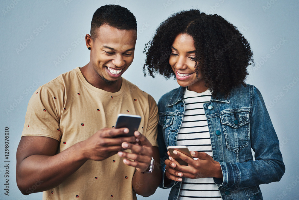 Happy couple, chatting or social media with phone in studio for conversation or online network on a blue background. Excited, man or woman with smile on mobile smartphone for data share or connection Happy couple, chatting or social media with phone in studio for conversation or online network on a blue background. Excited, man or woman with smile on mobile smartphone for data share or connection