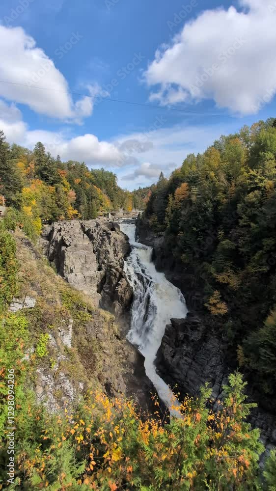 Waterfall of Canyon Sainte Anne- Quebec Canada during fall months with yellow trees Waterfall of Canyon Sainte Anne- Quebec Canada during fall months with yellow trees
