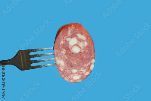 Wallpaper Mural a piece of meat sausage with bacon on a metal fork. background for the design. the blue color. Torontodigital.ca