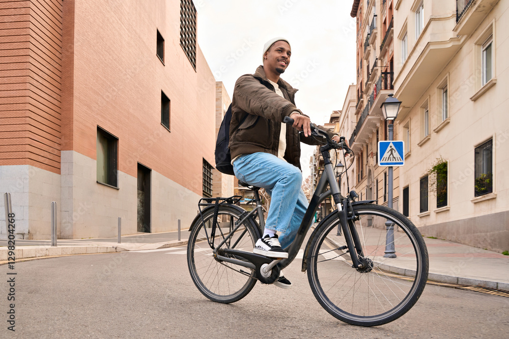Fototapeta premium Stylish student riding his bicycle in the city center