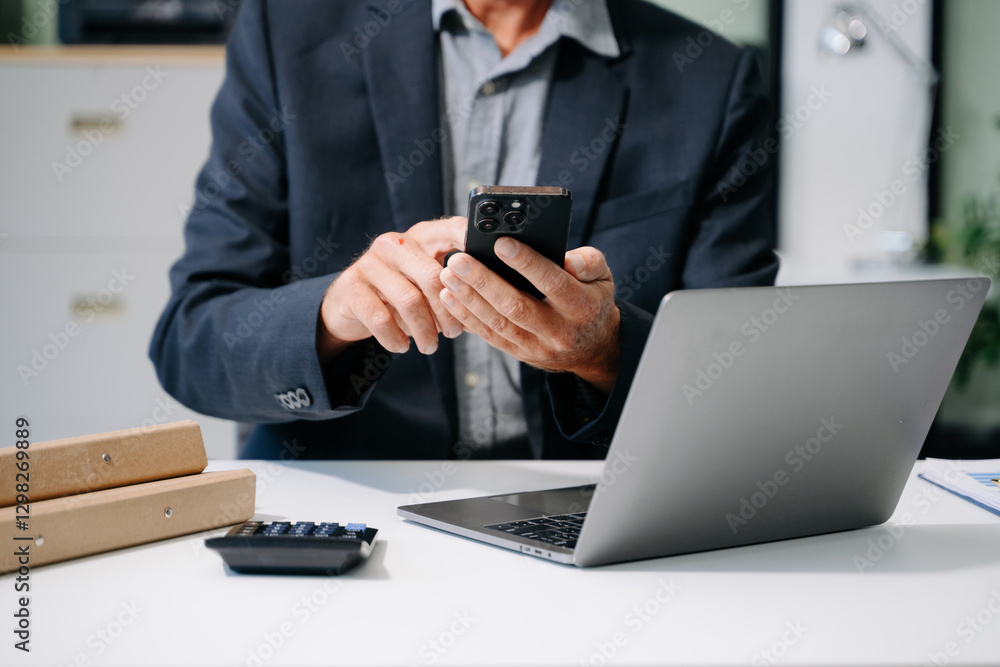 Confident businessman working on laptop, tablet and smartphone at her workplace Confident businessman working on laptop, tablet and smartphone at her workplace