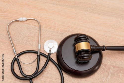 A gavel and stethoscope on wooden background, The law in medicine and medical negligence