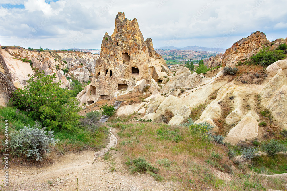 Majestic rock formations and ancient dwellings create a mystical landscape in Cappadocia.