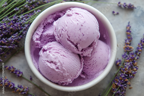 Obraz na płótnie Creamy lavender honey ice cream scoops in white bowl, surrounded by fresh lavender flowers, creating rich and smooth texture. delightful treat for dessert lovers w salonie