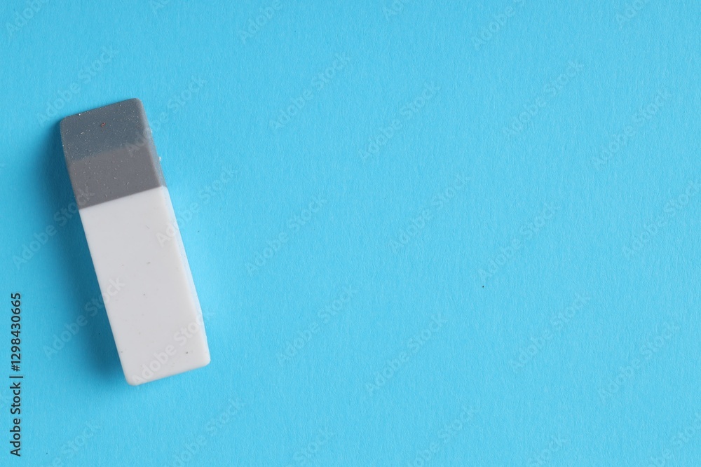 One eraser on light blue background, top view. Space for text One eraser on light blue background, top view. Space for text