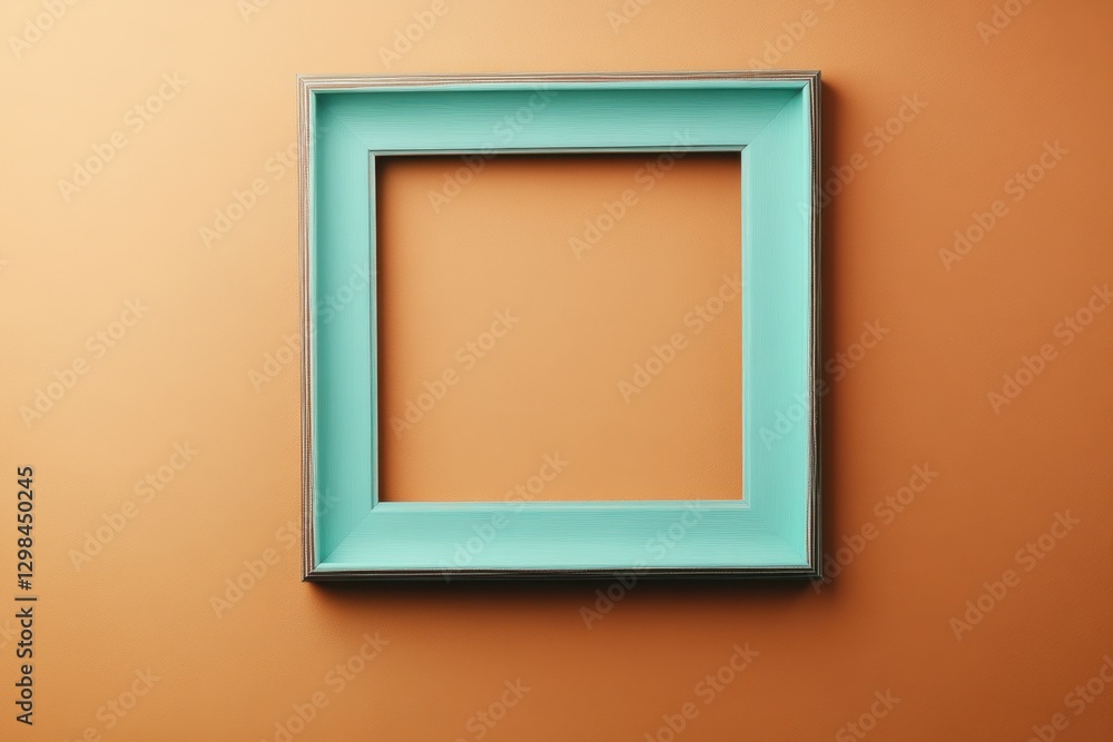 A teal colored picture frame hanging on a wall background A teal colored picture frame hanging on a wall background