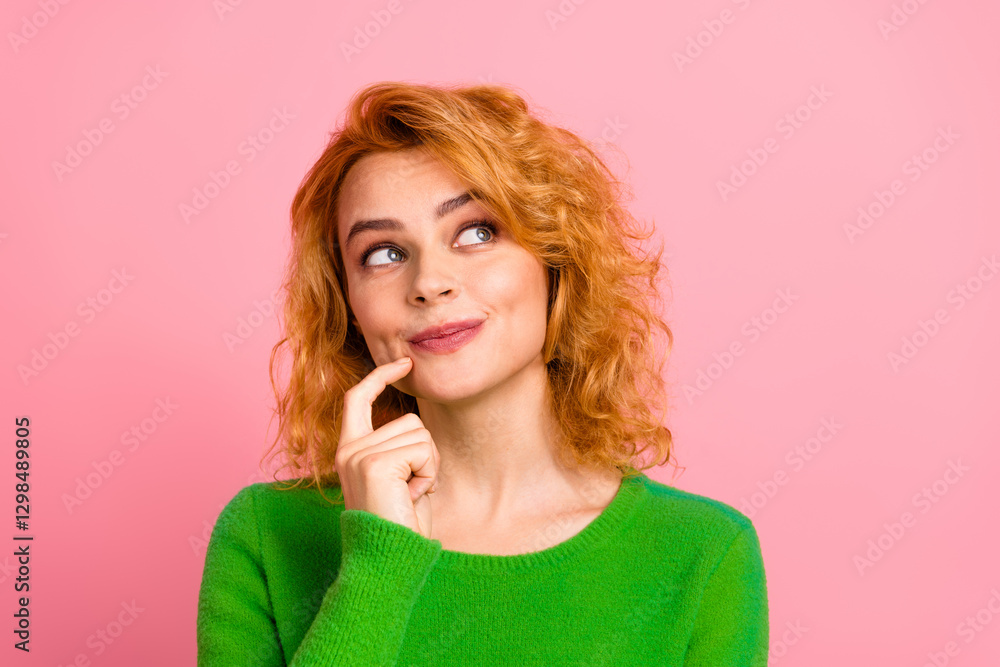 Charming Young Woman in Green Sweater Smiling Playfully Against a Pink Background Charming Young Woman in Green Sweater Smiling Playfully Against a Pink Background