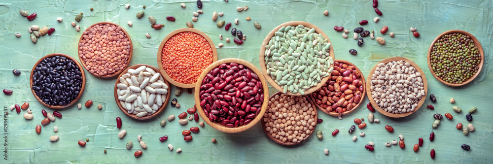 Various legumes, overhead flat lay panorama on a blue background. Many different pulses, an assortment, panoramic banner Various legumes, overhead flat lay panorama on a blue background. Many different pulses, an assortment, panoramic banner