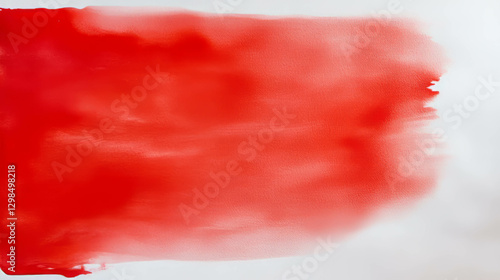 Vibrant red ink blot on textured paper for creative design concepts