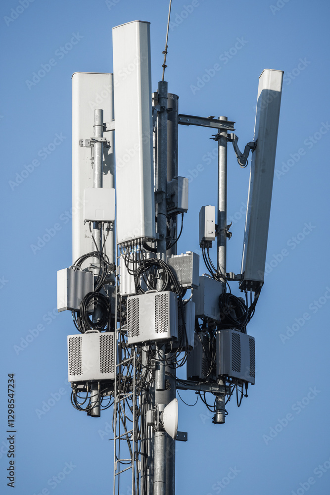 A telecommunications cell tower featuring multiple antennas A telecommunications cell tower featuring multiple antennas