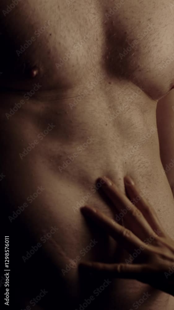 Female hands touching male's fit torso with passion. Slow motion. Vertical orientation Female hands touching male's fit torso with passion. Slow motion. Vertical orientation