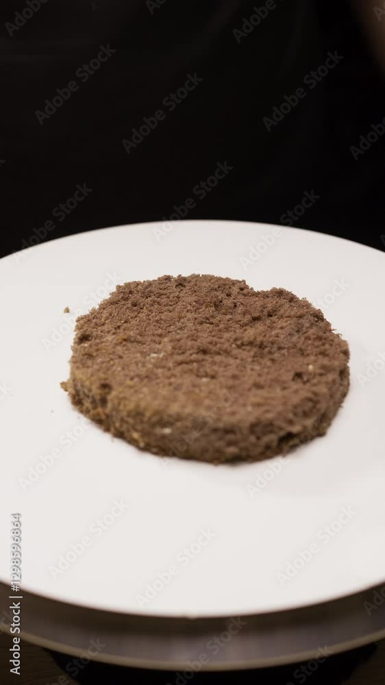The process of making bento cake, confectioner putting chocolate base on cakes stand The process of making bento cake, confectioner putting chocolate base on cakes stand
