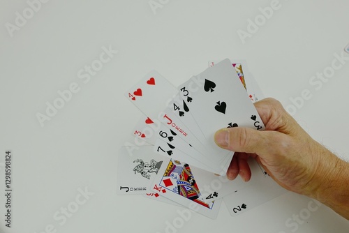 Poker cards scattered on the table and in my hand.