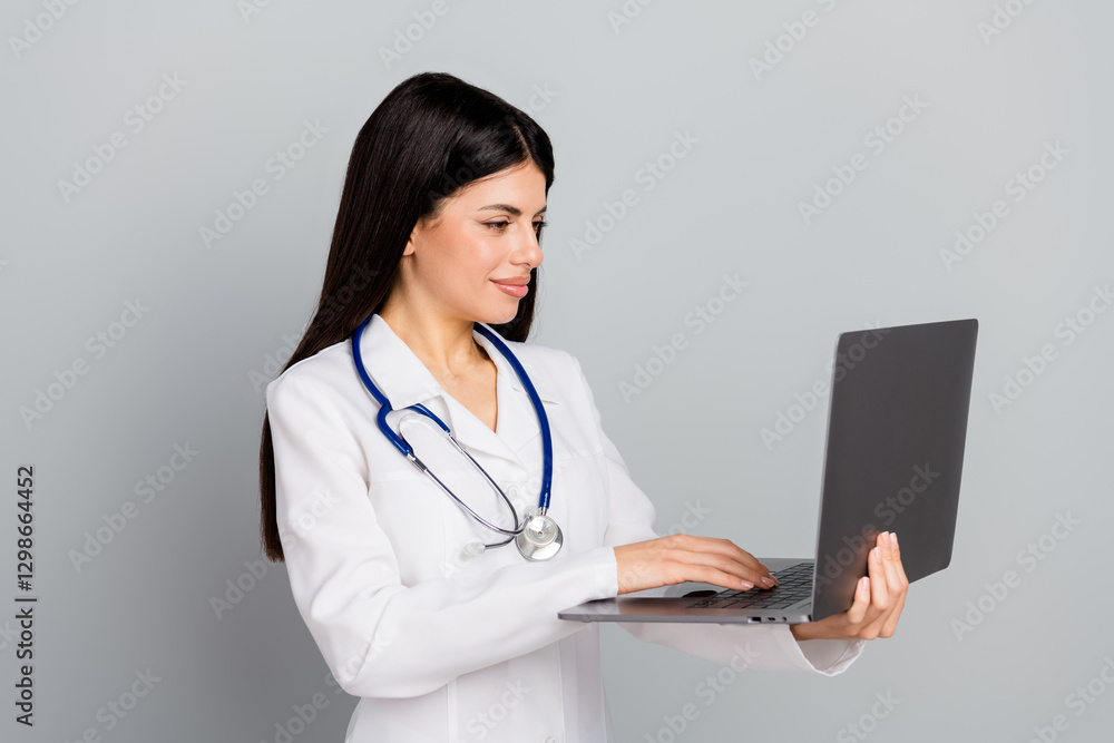 Professional doctor in medical uniform using a laptop for healthcare work Professional doctor in medical uniform using a laptop for healthcare work