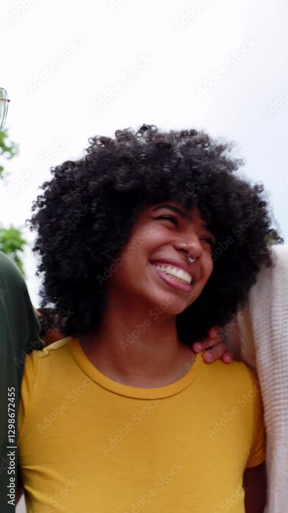Vertical HD video of multiethnic group of young people having fun together outdoor. Youth community friends and international friendship lifestyle concept Vertical HD video of multiethnic group of young people having fun together outdoor. Youth community friends and international friendship lifestyle concept