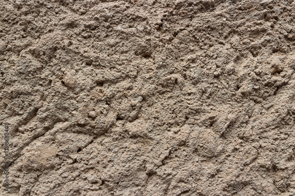 Background of grey rough uneven cement plaster with grainy sand texture Background of grey rough uneven cement plaster with grainy sand texture