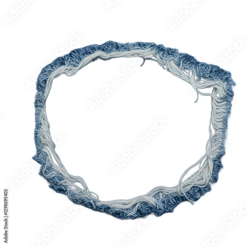 A circular torn denim fabric with frayed white and blue threads, forming a rough, uneven hole.