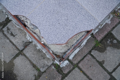 Close up view of broken tile. Cracked asbestos floor tile. Damaged ceramic tile background. bad. bad construction concept