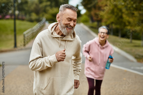 Joyful moments shared during an afternoon jog in the park between a loving mature couple