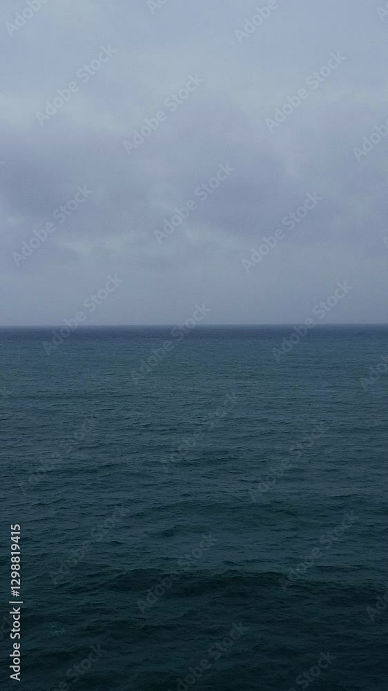 An aerial view of the sea on a cloudy day, bad weather. Gloomy atmosphere. Vertical video. An aerial view of the sea on a cloudy day, bad weather. Gloomy atmosphere. Vertical video.