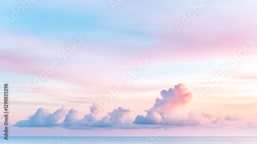 serene pastel sky with soft clouds over calm ocean creates tranquil atmosphere