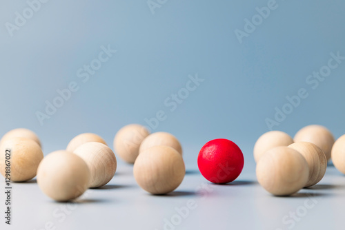 Papier peint Unique red ball in the grouo of wooden red balls, being different concept, notic