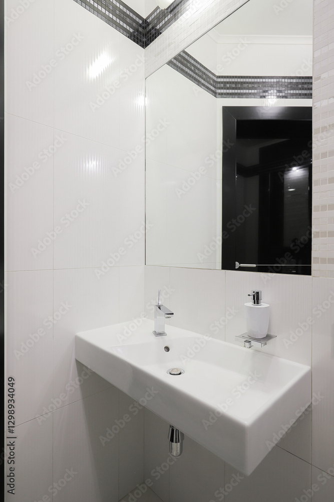 Faucet with ceramic sink and mirror in the bathroom Faucet with ceramic sink and mirror in the bathroom