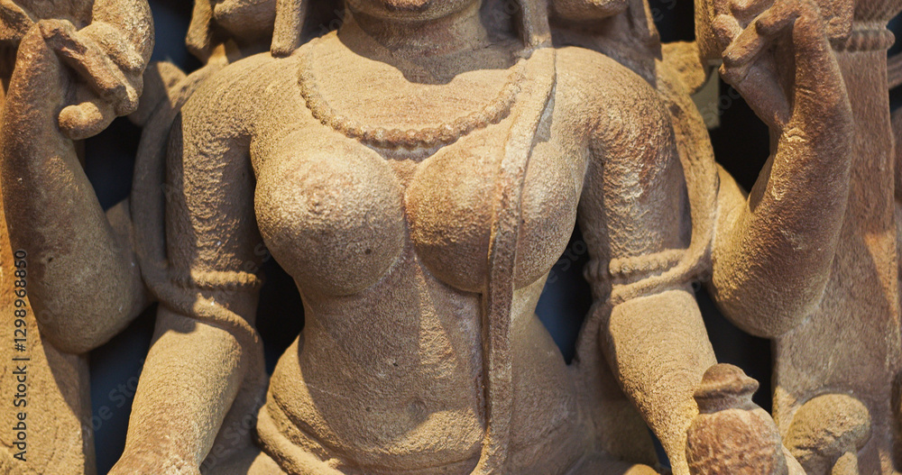 Close-up view on Ancient Stone Bas-relief Of Brahmani Or Brahmi, One Of Seven Hindu Mother Goddesses Known As Sapta Matrikas. She Is Aspect Of Adi Shakti, Possessing rajas Guna And Is Therefore Source
