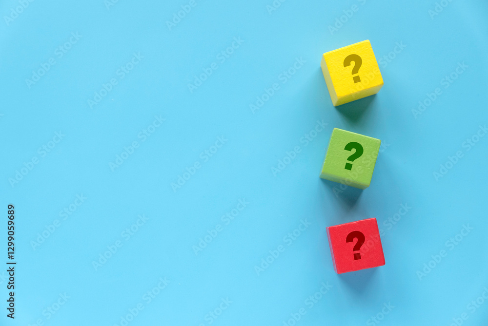 Colorful Wooden Blocks with Question Marks on Blue Background Colorful Wooden Blocks with Question Marks on Blue Background