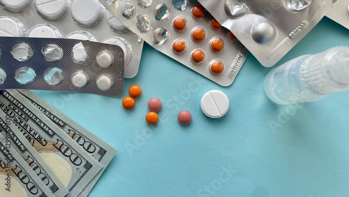 Obraz na plátně Pills, Money, and Medication on a Blue Background, tablets, blister pack, Rising