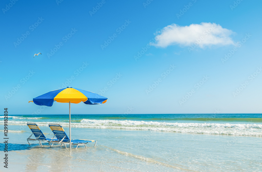 Two beach chairs and a parasol on the sand