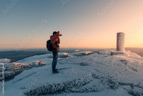 Photographer Capturing Snowy Sunrise at Siete Picos Summit