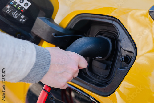 Charging electric car with plug in at station for eco-friendly drive photo