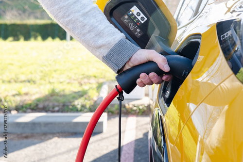 Plugging In an Electric Car at a Charging Station