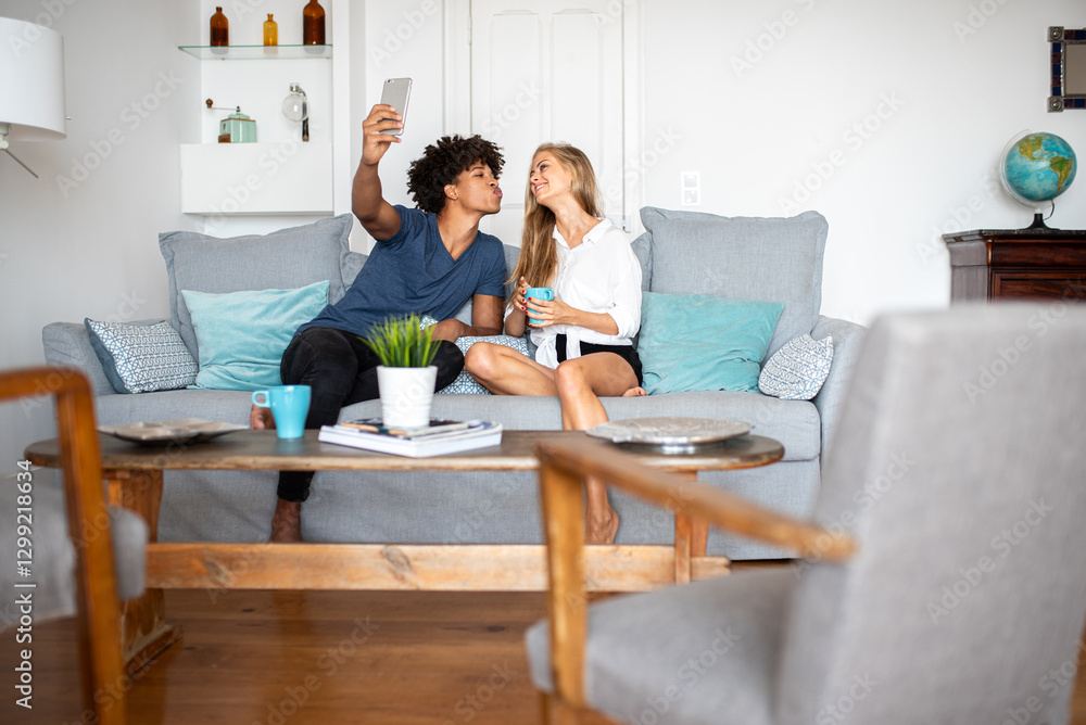 Couple Enjoying Selfie Moment on Cozy Living Room Sofa Couple Enjoying Selfie Moment on Cozy Living Room Sofa
