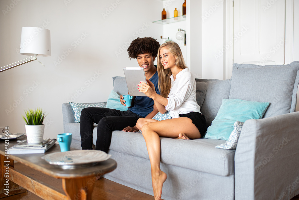Couple Relaxing on Couch with Tablet in Comfortable Home Setting Couple Relaxing on Couch with Tablet in Comfortable Home Setting