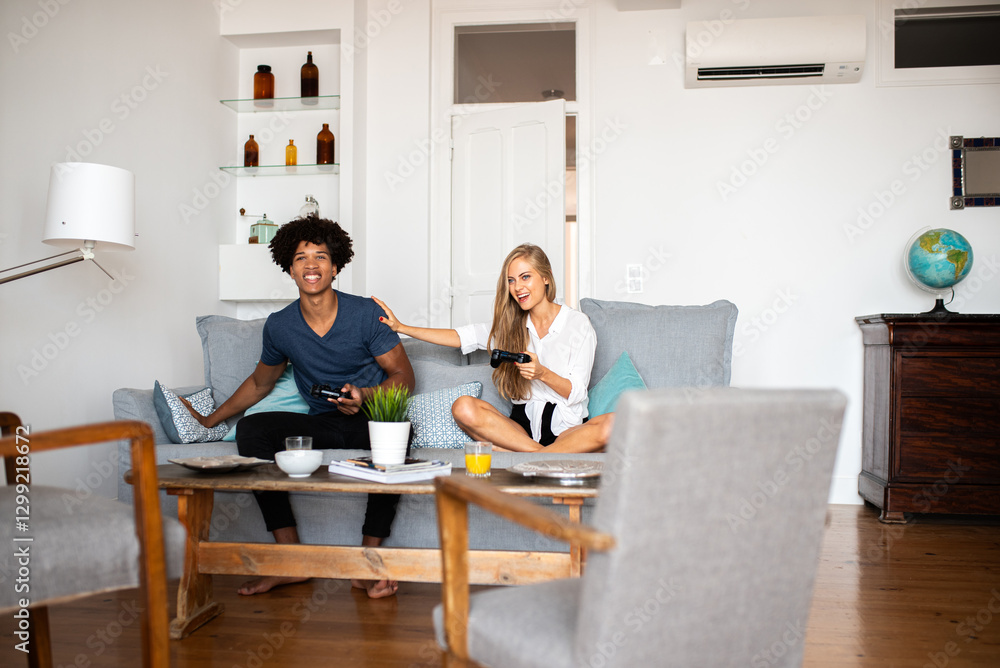Friends enjoying video game together on cozy sofa as celebration unfolds. Friends enjoying video game together on cozy sofa as celebration unfolds.