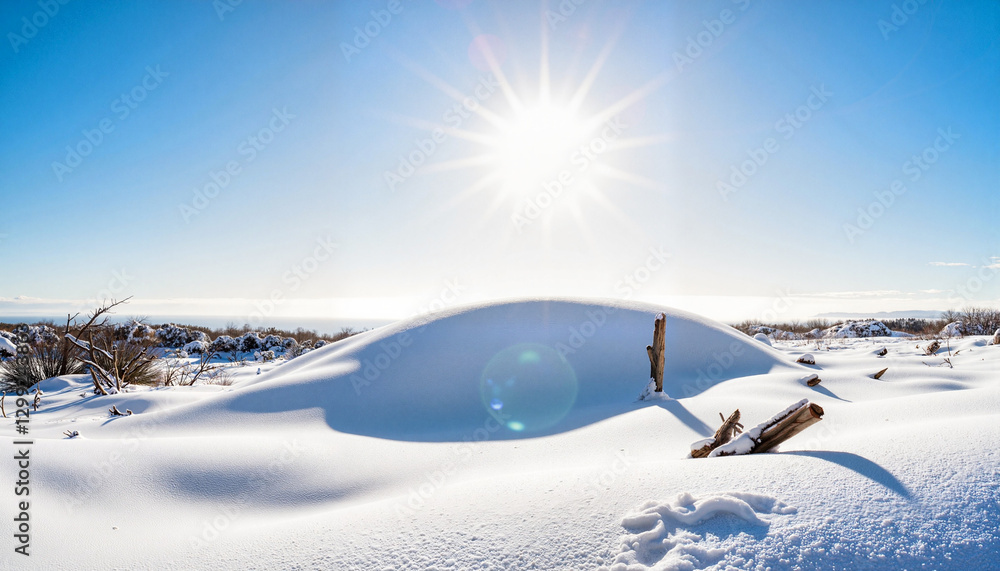 Bright sun illuminating serene snowbank in coastal landscape, tranquility Bright sun illuminating serene snowbank in coastal landscape, tranquility