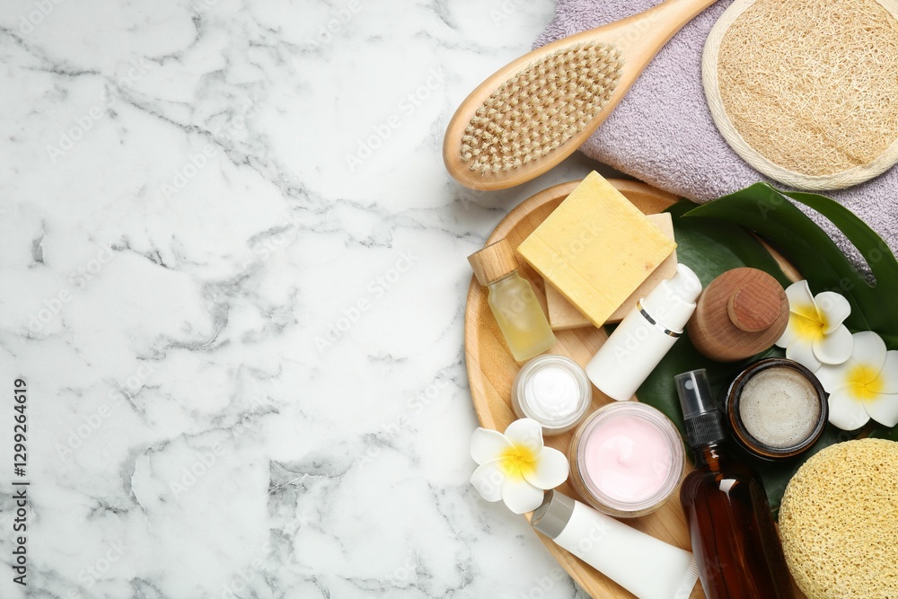 Fototapeta premium Flat lay composition with different body care products on white marble table. Space for text